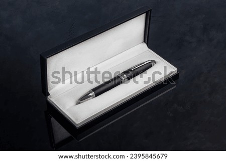 Fountain pen on marble and gray background. Gift concept. Copy space