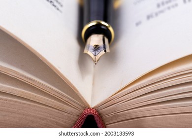 fountain pen on old open book. - Powered by Shutterstock