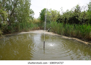 Fountain in the pond. A simple fountain without complex designs.
