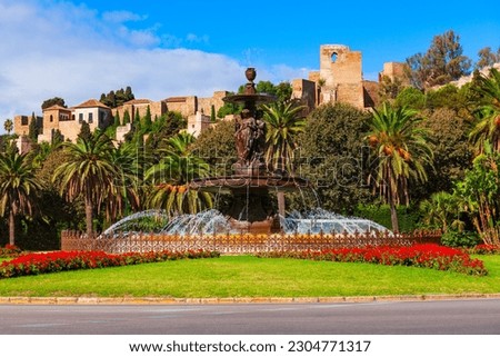 The fountain of the Three Graces or Fuente de las Tres Gracias and Malaga Fortress. Malaga is a city in the Andalusia community in Spain.