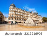 Fountain of the Three Graces at the Place de la Comedie, main square in Montpellier city in southern France. People are with blurred faces.