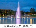 Fountain. Fountain in UCF University of Central Florida. Orlando FL. Fountain, colorful lights at night. Reflection in water. Professional long exposure photography. Tropical nature. Evening city park