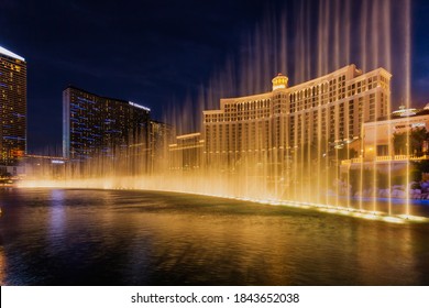 Fountains of Bellagio hotel with bright lights of hotels on Las Vegas Strip in Paradise, Nevada. Las Vegas, USA - September 28, 2018.