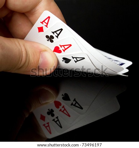 Four aces in the hand with reflection