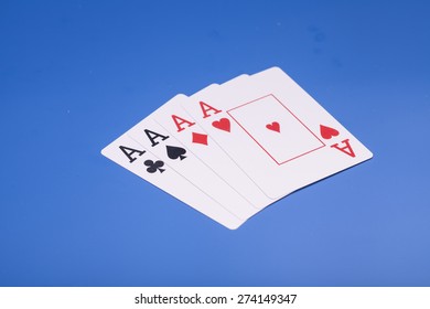 Four aces isolated on blue background - Shutterstock ID 274149347