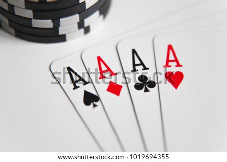 Four aces playing poker cards with tokens on white background, four of kind, top view