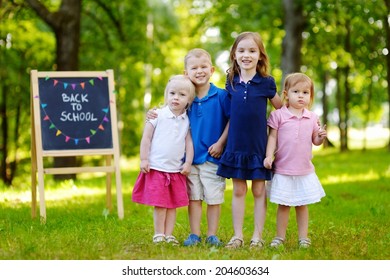 Four adorable little kids feeling very excited about going back to school - Shutterstock ID 204603634