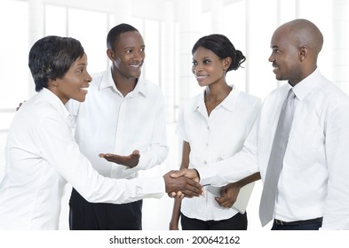 Four african business partners shake hands, Studio Shot