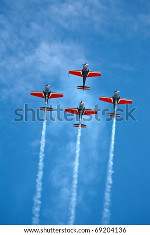 four airplanes in formation on airshow