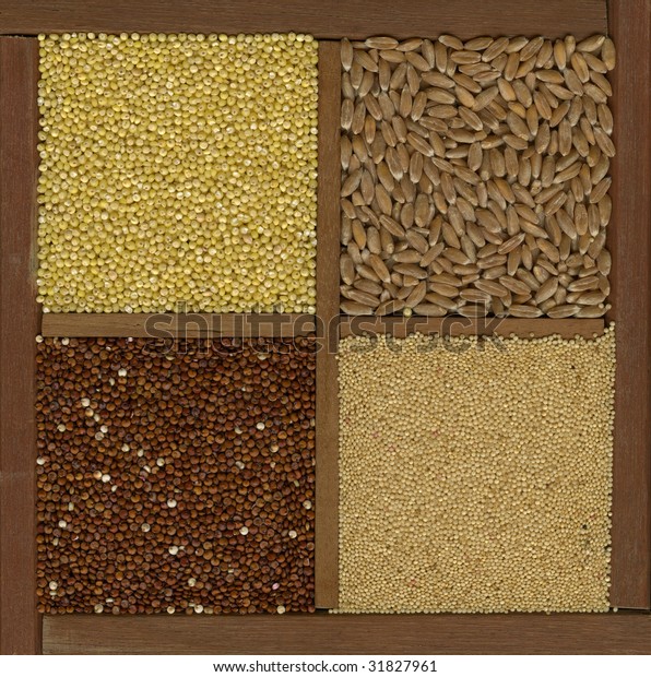 four ancient cereal\
grains - millet, spelt, amaranth, red quinoa in a wooden box or\
drawer with dividers