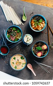 Four asian soups served in blue dishes on dark table in restaurant - Shutterstock ID 1059742637