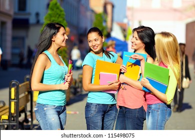 Four Beautiful College Girls Talking On The Street