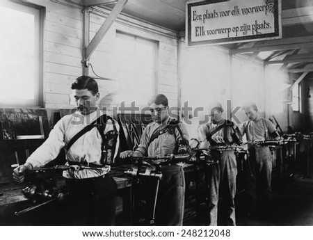 Four Belgian WW1 veterans with a prosthetic arms working in a machine shop in 1917. The occupational therapy took place at the Institute de Port Villez, Belgium.