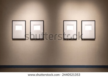 four blank picture frames with clipping path on exhibition wall