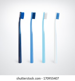 Four blue toothbrushes on studio background - Shutterstock ID 170955407