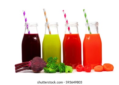 Four bottles of vegetable juice, beet, greens, tomato, and carrot with ingredients, isolated on white