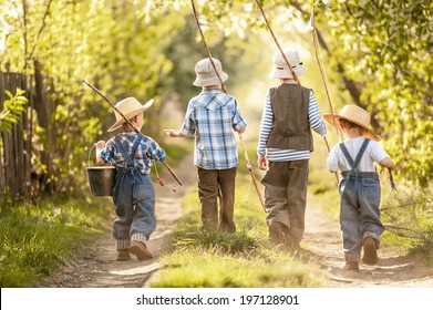 Four boys with fishing rods go on a fishing trip on the narrow rural road in sunny summer day - Powered by Shutterstock