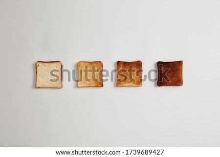 Similar – Image, Stock Photo Toasted toast bread in toaster on pink background