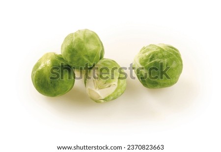 Four brussels sprouts isolated with clipping path on a white background. Heap of green vegetables.