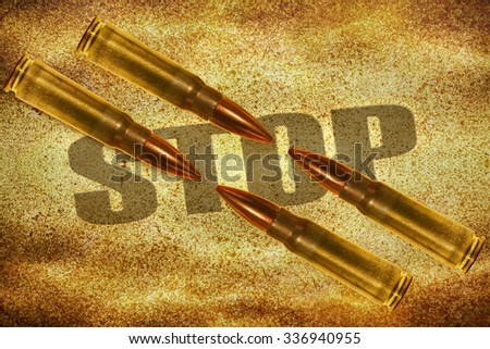 Four bullets and word Stop written on yellow grungy background