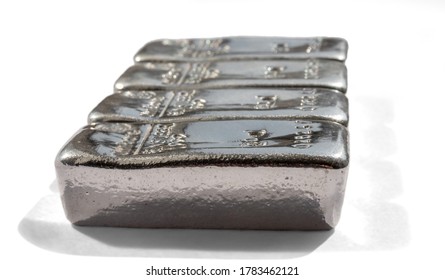Four bullions bars of precious metal are isolated on a white background.
