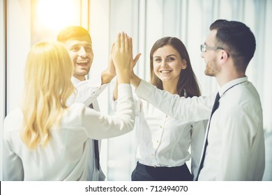 Four Business People Greeting High Five Stock Photo 712494070 ...