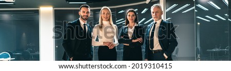 The four business people standing indoor