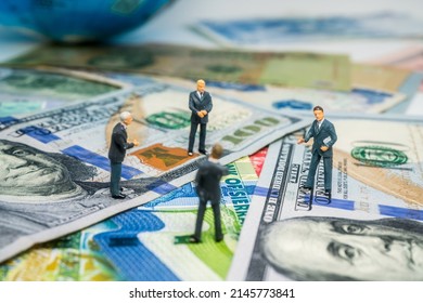 Four businessmen Standing on paper money, take a meeting - Shutterstock ID 2145773841