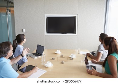 Four Businesspeople Having Video Conference In Boardroom