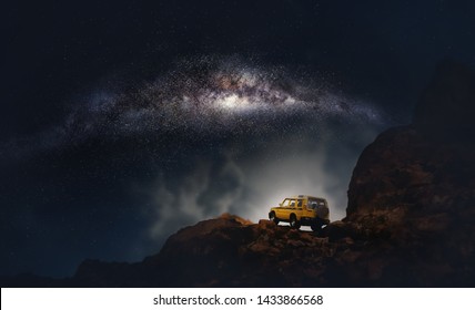 Four by four off road car crossing through the country road against the milky way and stars in the night. (Elements of this image furnished by NASA)