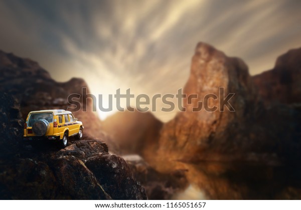 Four by four off road car crossing through the country\
road. Travel and racing concept for four wheel drive off road\
vehicle .
