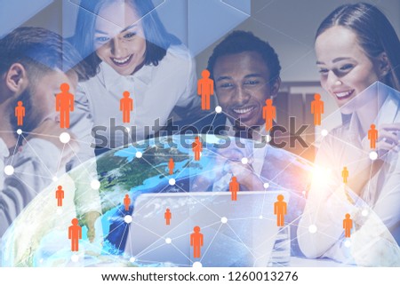 Four cheerful business people working together in office with Earth and global people network hologram in foreground. Toned image double exposure Elements of this image furnished by NASA
