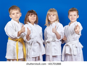 Four cheerful child standing in a white kimono on a blue background
