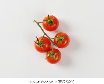 Four Cherry Tomatoes On Vine