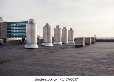 Four Chimney On The Flat Roof Off A Big Building In The City