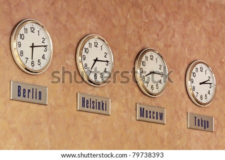 Four clocks, showing the time in different cities of the world on the wall