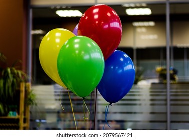 Four Colorful Balloons On Ribbons In The Office To Create A Festive Mood And Congratulations To Colleagues On Their Birthday