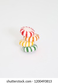 Four Colorful Starlight Mints Stacked On A White Background