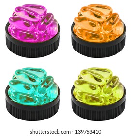 Four Colors Of Liquid Soft Gels In The Black Container. It Can Be Referred To Drug, Cure, Vitamin Or Poison.