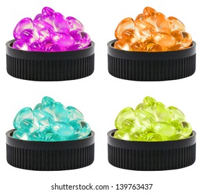 Four Colors Of Liquid Soft Gels In The Black Container. It Can Be Referred To Drug, Cure, Vitamin Or Poison.