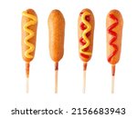 Four corn dogs with different toppings isolated on a white background