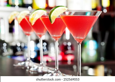 Four Cosmopolitan Cocktails On A Bar