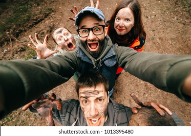 Four crazy funny people selfie. Bizarre scary company mess outdoor. Disgusting creepy fellows fooling around. Unusual dirty face emotions. Wide angle distortions. Evil family. Expressive men, women