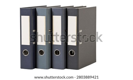 Four dark blue office ring binders standing in a row