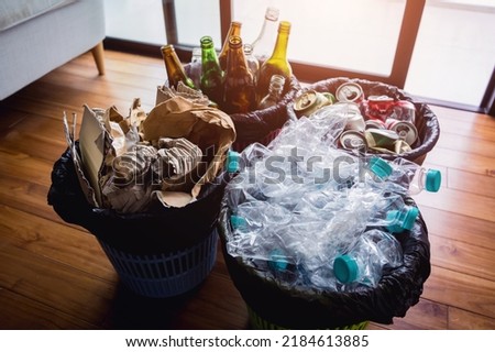 The four different container for sorting plastic, paper, metal and glass waste