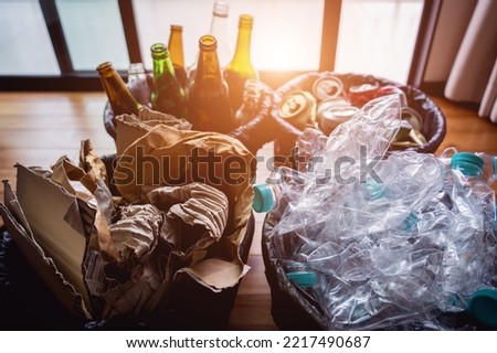 The four different container for sorting plastic, paper, metal and glass waste