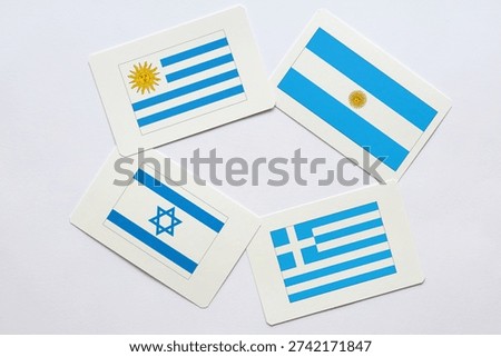 Four different but similar flags. Mostly white and blue colors. Uruguay, Argentina, Israel and Greece.