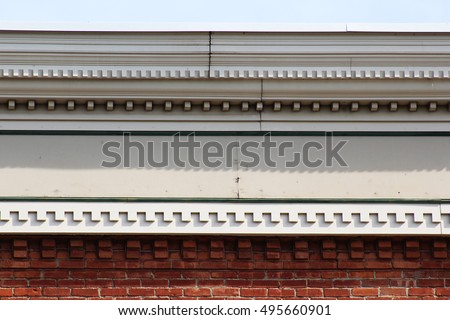 Four different styles of dentil molding and corbels on cornice of old building 