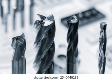 Four different types of drill bits are shown, with one of them being a spiral. Concept of precision and technicality, as these tools are commonly used in manufacturing and construction - Powered by Shutterstock