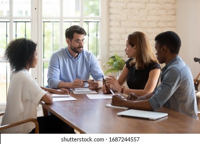 Four Diverse Business Partners Negotiating In Boardroom. Businesspeople Talking Solving Issues Together, Workgroup Working On Common Project, Share Solutions, Meeting Lead By Caucasian Female Leader